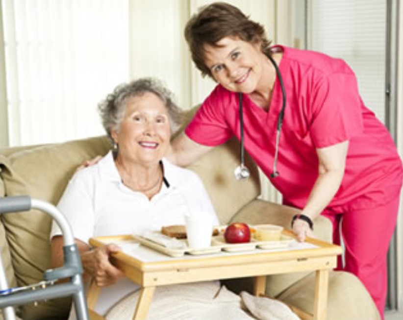 elderly woman smiling with nurse